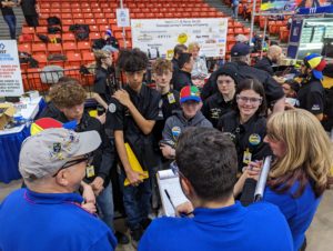 Students Levi Flowers, Michael Whiddon, Matthew Marksberry, Sarah Herko, Zosia Dupont, and Courtney Wilcox speak with judges about their robot and team.