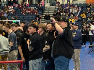 Mentor Tyler Nimmagadda, Junior Ari Flowers, Senior Alexzander Thornton, Mentor Alex Richards, Senior Michael Whiddon, and Mentor Travis Hoffman gather to see the final score.